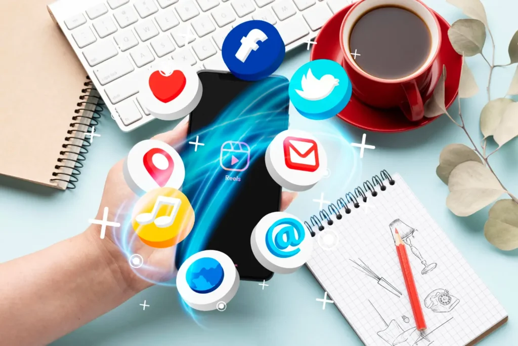 Hand holding smartphone with social media app icons floating around, representing digital marketing, social media communication, online networking, and mobile content engagement.